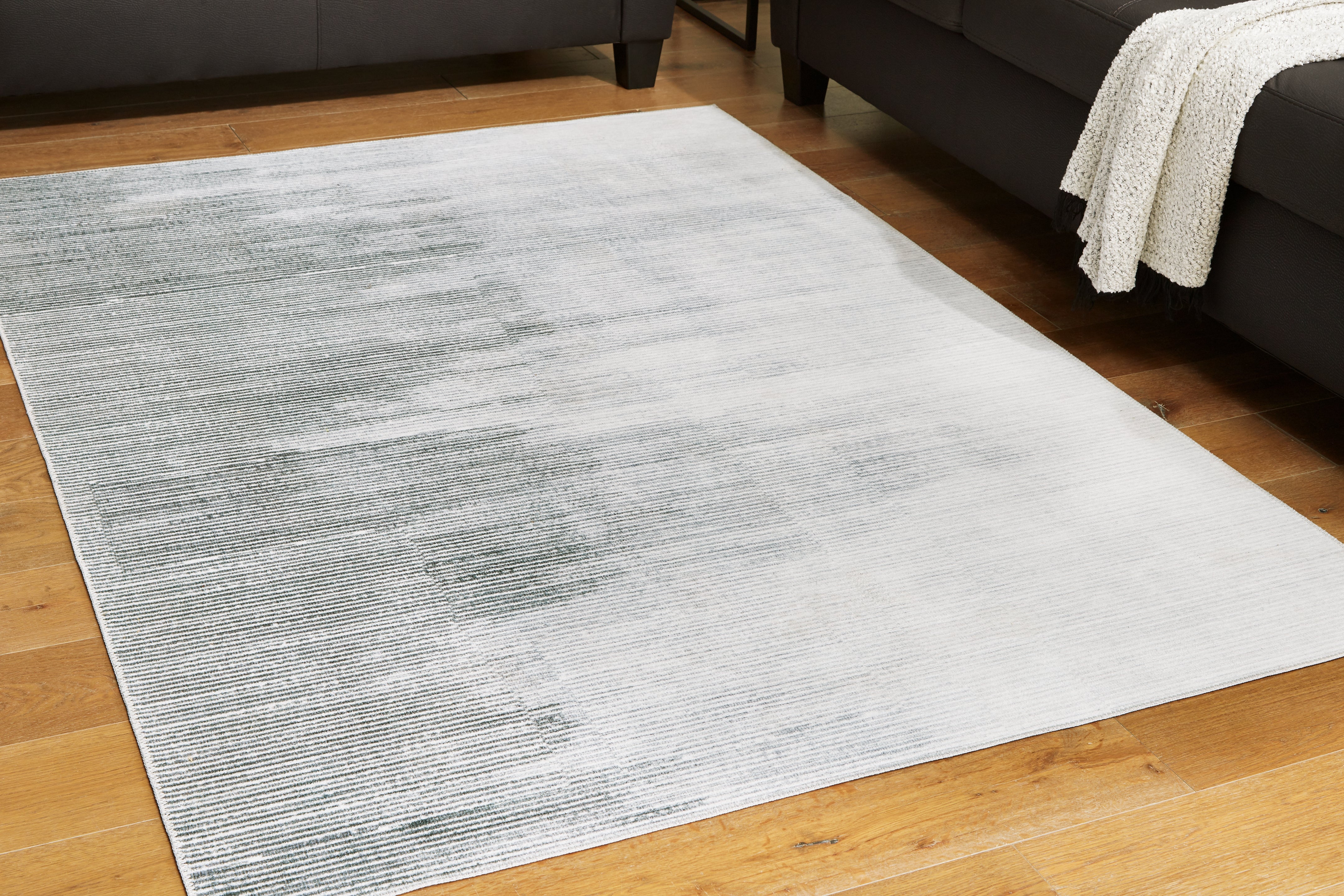 Floridian Furniture - Ashley Furniture - Milset Rug - 8'1" x 10' Washable Rug / Black/White/Gray - R406251